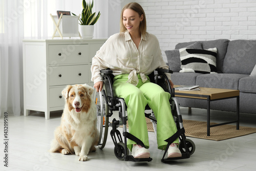Young woman in wheelchair with service dog at home