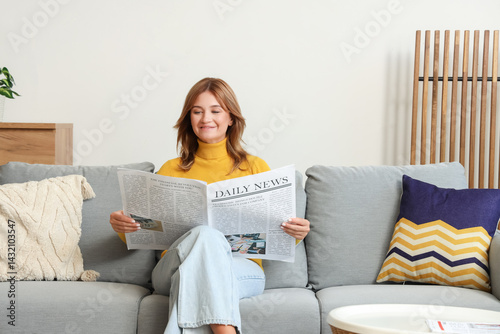 Pretty young woman reading ...