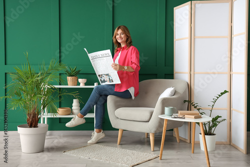 Relaxed woman reading newsp...