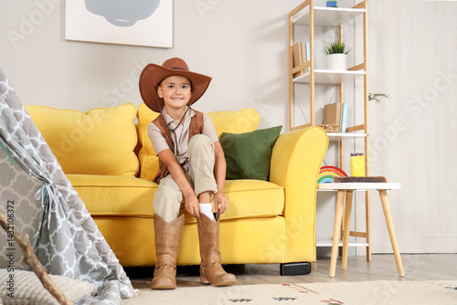 Smiling young boy in cowboy...