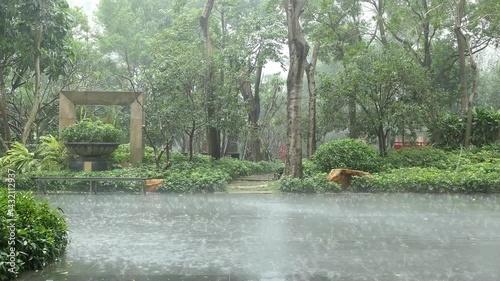 garden of apartment community in heavy rain at horizontal composition video with sound
