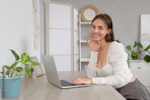 Beautiful young woman using...