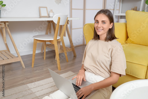 Young woman using laptop on...
