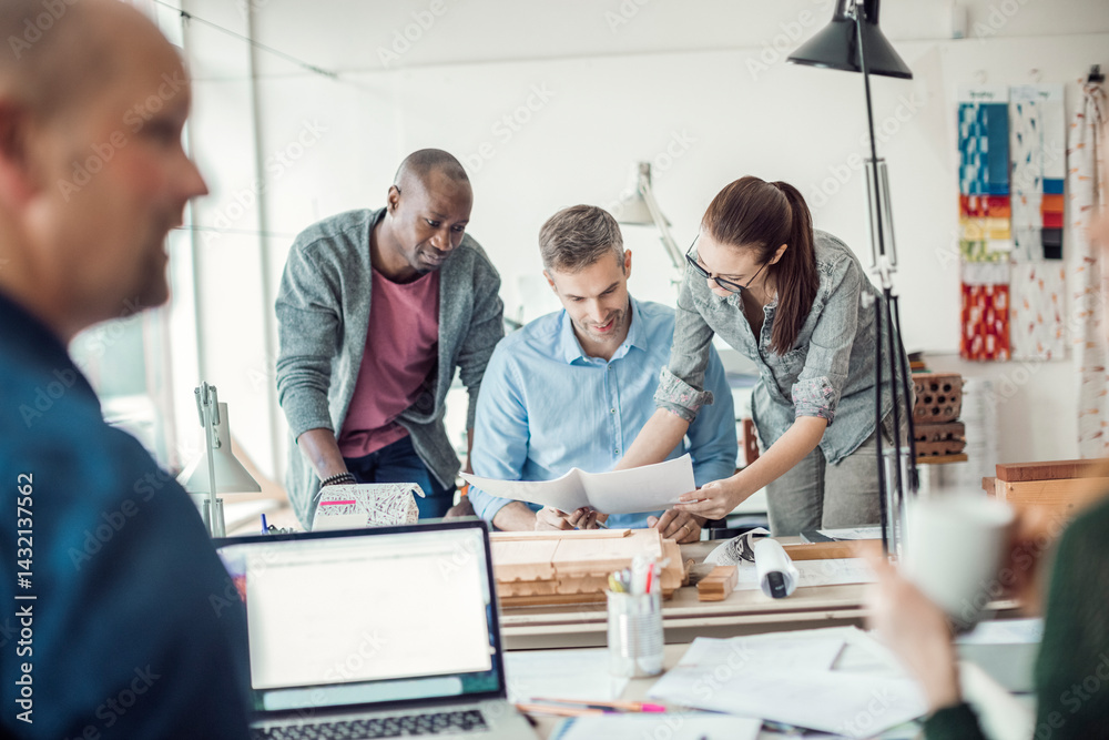 Group of people working together on a project in a startup company office Group of people working together on a project in a startup company office