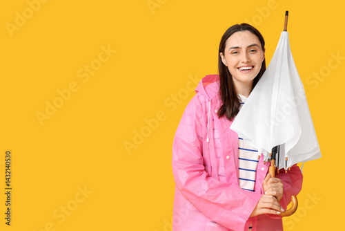 Happy young woman in rainco...