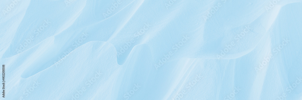 Snow texture. Wind sculpted patterns on snow surface. Wind in the tundra and in the mountains on the surface of the snow sculpts patterns and ridges (sastrugi). Arctic, Polar region. Winter background