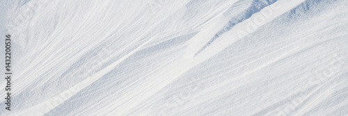 Obraz na płótnie Beautiful winter background with snowy ground. Natural snow texture. Wind sculpted patterns on snow surface. Wide panoramic texture for background and design. w salonie