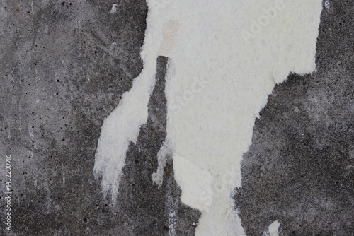 Obraz na płótnie Torn old faded paper wallpaper on a concrete wall. Ragged scraps of white paper on a gray background. Vintage texture for background and design. Closeup view with copy space for text. High resolution. w salonie