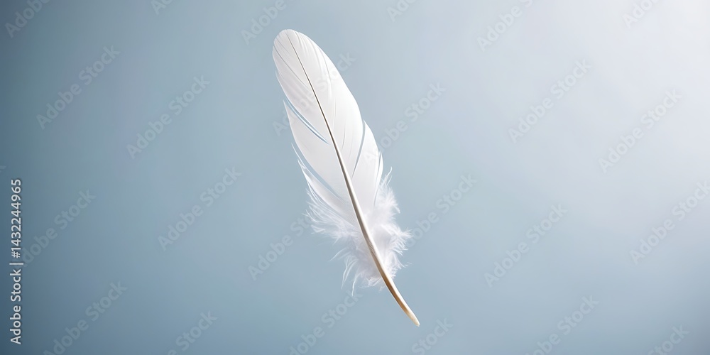 Obraz premium White feather floating gently in the air on a soft blue background, symbolizing peace, purity, and lightness in a minimalistic and serene visual concept