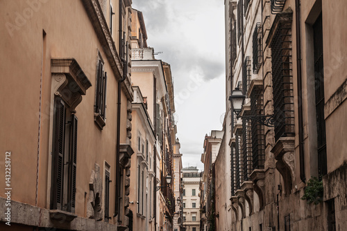 Photography Narrow historic street in the center of Rome, lined with traditional Italian residential architecture, indicative of old Roman property in the old rome, the capital city of italy