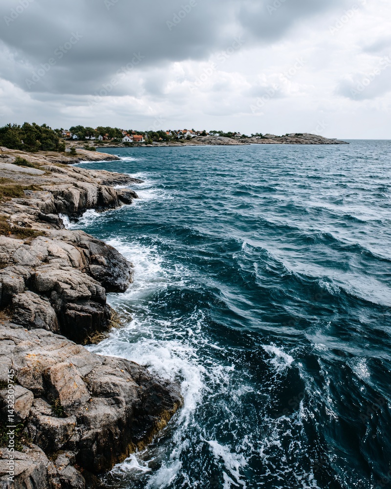 Serene Coastal Landscape with Rocky Shoreline and Turquoise Sea Under Cloudy Sky
