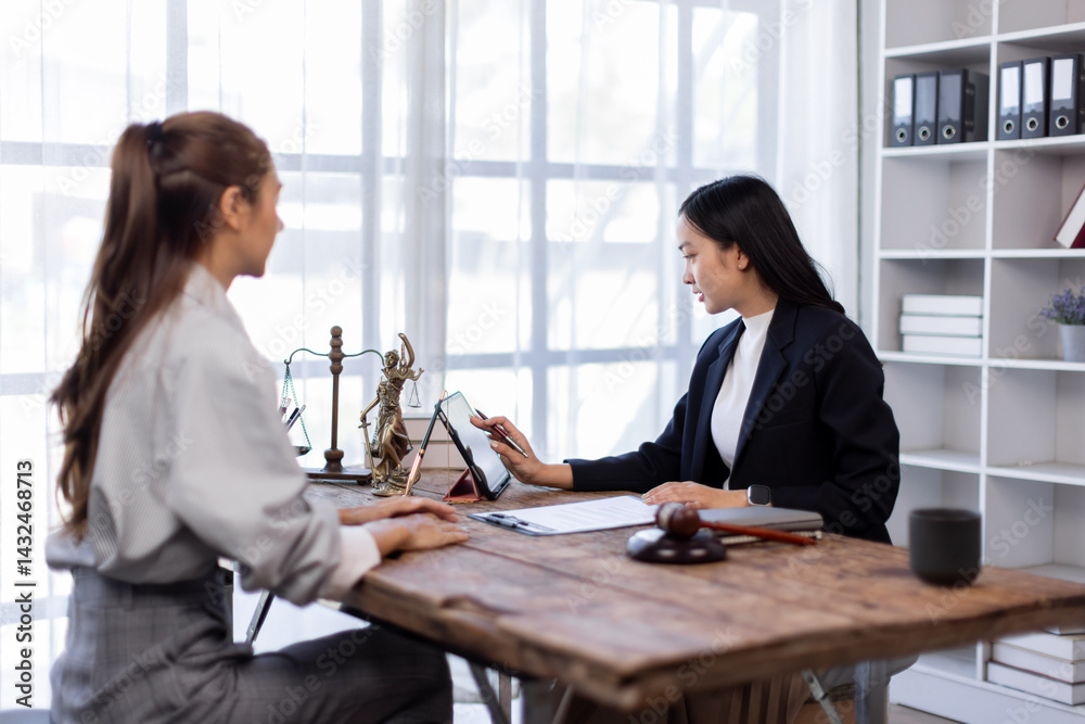 Two lawyers in suits discussing legal matters at a desk with a gavel, scales of justice, and a law book, symbolizing law and justice, justice and lawyer Business partnership meeting concept.
Two lawyers in suits discussing legal matters at a desk with a gavel, scales of justice, and a law book, symbolizing law and justice, justice and lawyer Business partnership meeting concept.