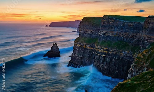 Breathtaking sunset over cliffs and ocean waves at the stunning coastline