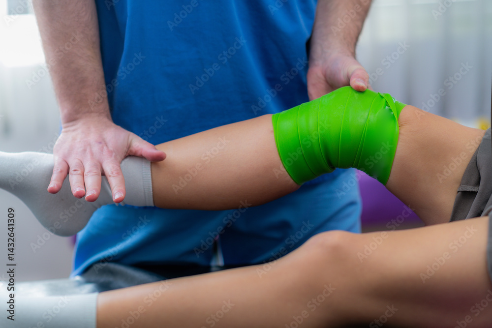 Fototapeta premium Woman undergoing smart flossing therapy on her knee during a physical therapy session. Tissue flossing helps improve mobility, reduce pain, and enhance circulation for injury recovery 