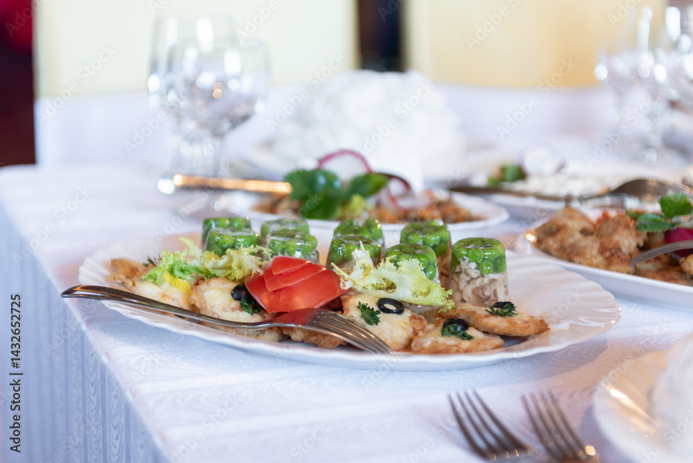 Elegant Plate of Appetizers with Vegetables and Garnishes on a Table Elegant Plate of Appetizers with Vegetables and Garnishes on a Table