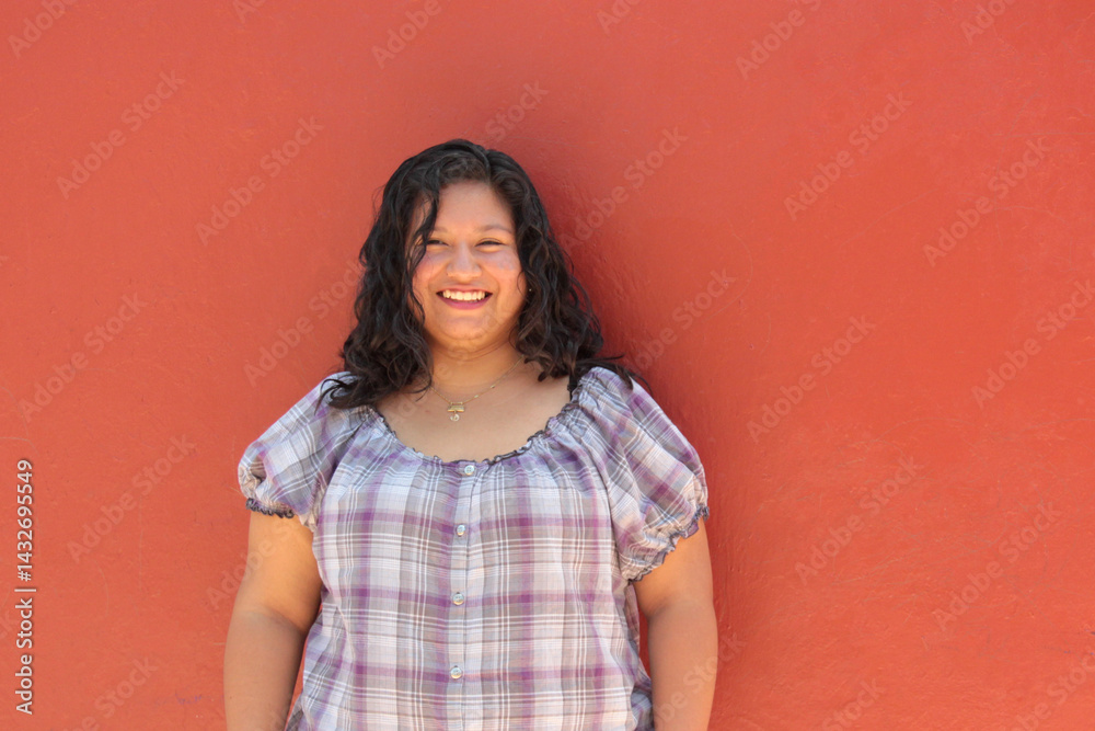 Obraz premium 25-year-old single Latina brunette woman with curly hair shows herself to be happy, empowered, successful, and living a full life