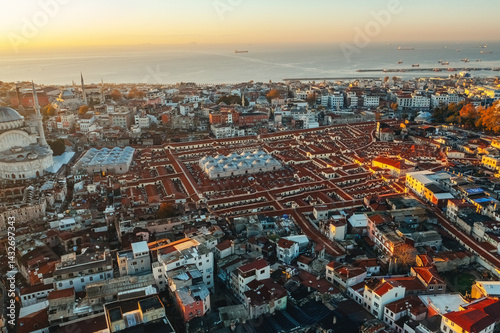 Istanbul Grand Bazaar. Aerial view of historic old city buildings, mosques and rooftops at sunset with the Sea of Marmara in the background. Turkey.