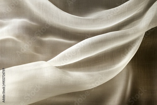 Delicate, flowing fabric draped in soft, muted tones.
