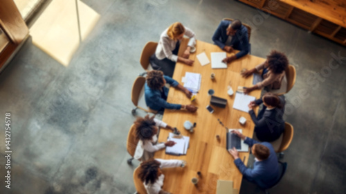 Obraz na płótnie Top view of a blurred team collaborating around a table. office setting filled with motion, brainstorming, and planning energy, symbolizing teamwork, workforce synergy, and modern work culture w salonie