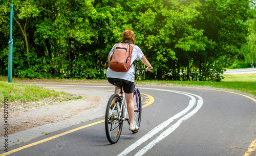 Wallpaper Mural Cyclist ride on the bike path in the city Park
 Torontodigital.ca