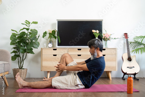 Wellness practices for elderly man strengthening core at home