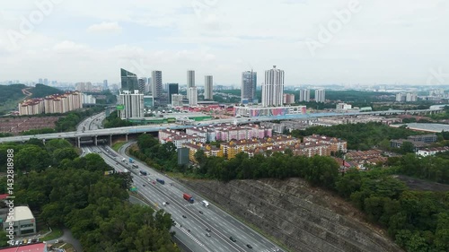 Aerial: cityscape of Petaling Jaya with traffic on a highway during the day in the state of Selangor, Malaysia, jib up drone shot photo