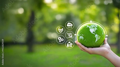 A hand holding a green planet Earth with circular economy and sustainability icons, Representation of SDG, eco friendly future, and renewable resources