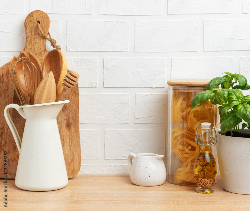 Kitchen utensils, pasta and basil showing rustic cooking and healthy food concept