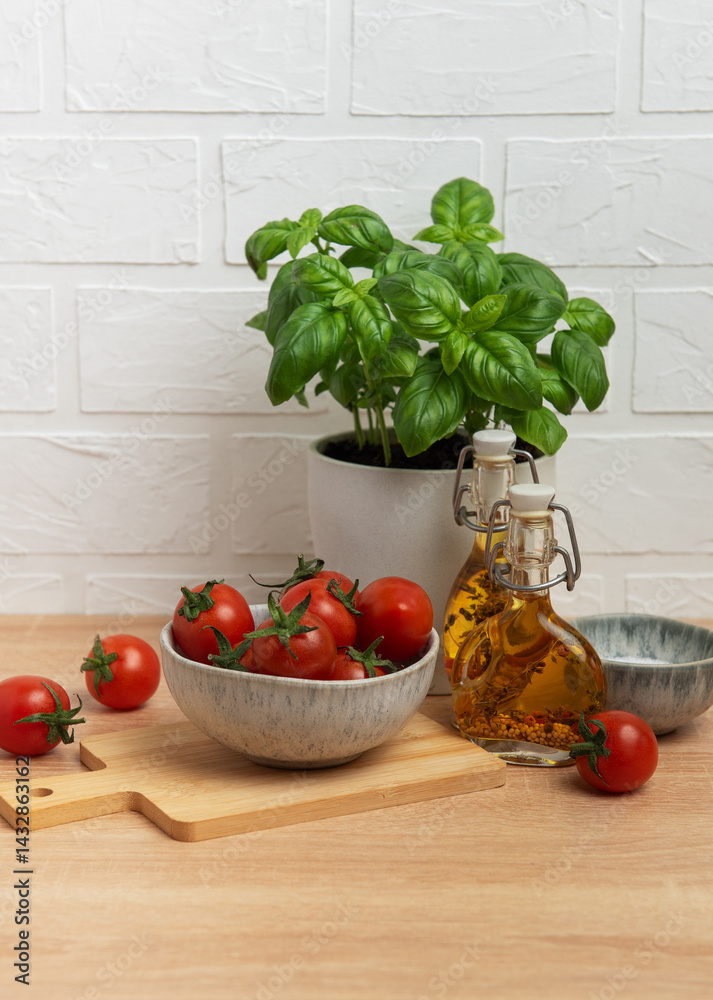 Cherry tomatoes and basil with olive oil on kitchen table