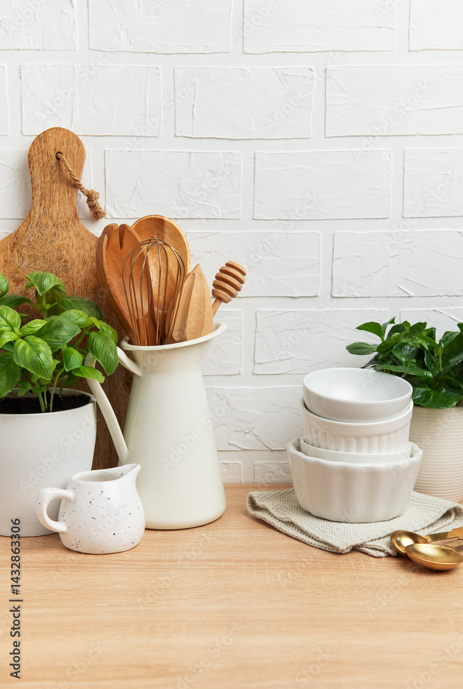 Kitchen utensils and plants creating cozy atmosphere on wooden countertop