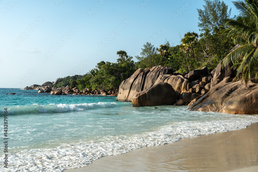 Anse Lazio beach on Seychelles with turquoise ocean, granite rocks, white sand, lush palms