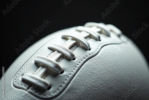 Close-up of white leather football, laces visible, pigskin, sports equipment, punt