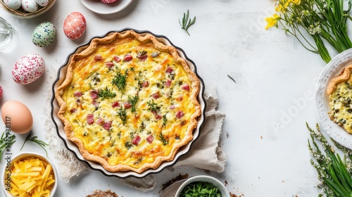 Easter quiche with ham, cheese, and herbs, surrounded by eggs and spring flowers.