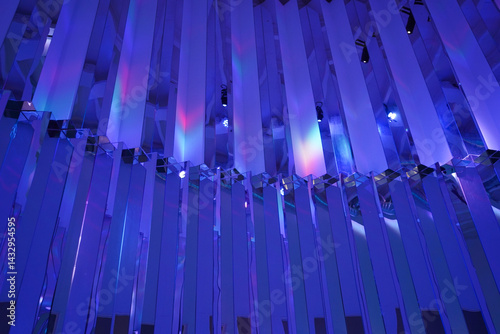 Abstract shimmery purple design pattern with rainbow reflections on the glitter wall