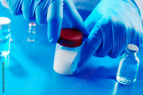 Obraz na płótnie laboratory worker opens a container with semen w salonie
