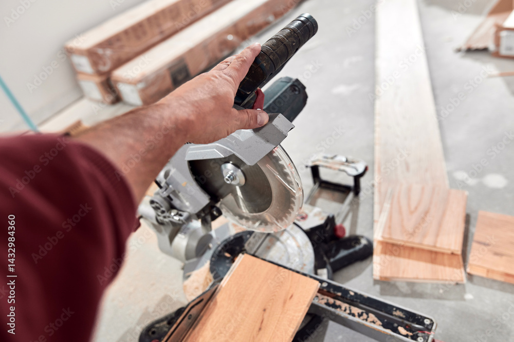 Professional handyman installing laminate flooring in a new apartment.
