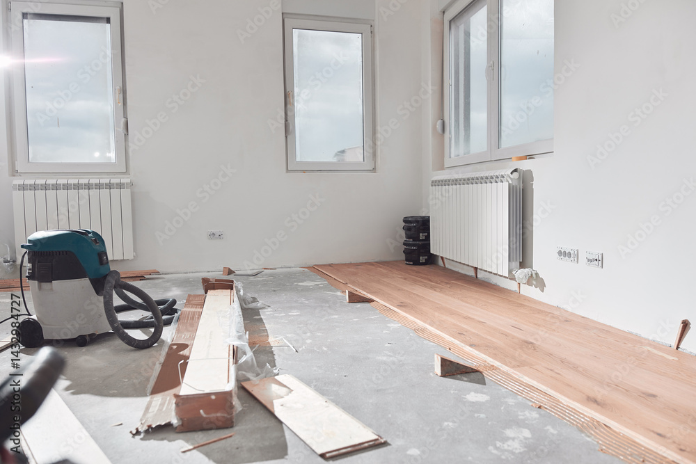 Assembling new laminate hardwood floor.