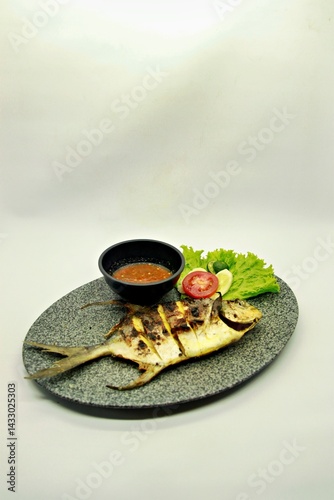 Grilled spadefish (bawal bintang) served with spicy seafood sambal. A savory Indonesian dish rich in flavor, perfect for traditional seafood lovers.
