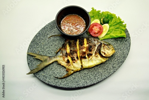 Grilled spadefish (bawal bintang) served with spicy seafood sambal. A savory Indonesian dish rich in flavor, perfect for traditional seafood lovers.