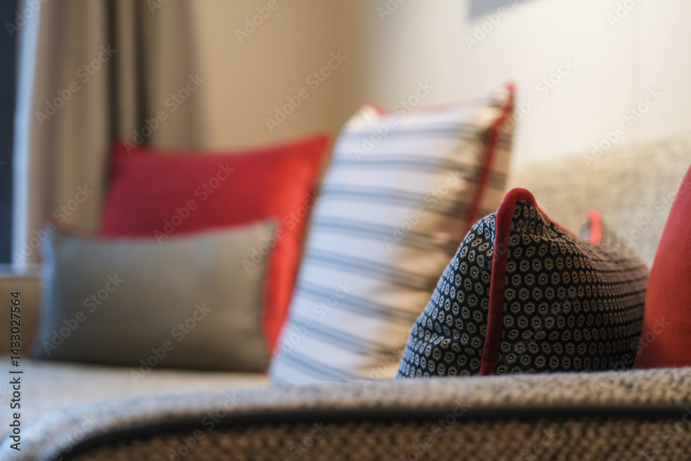 Luxurious mini suite stateroom cabin room onboard luxury cruise ship cruiseship ocean liner with bedroom and living area in red and creme with wood in modern Art Deco interior design