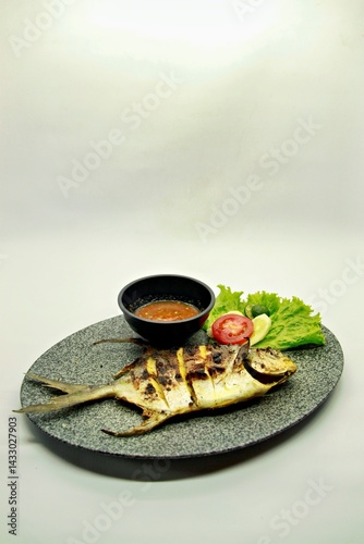 Grilled spadefish (bawal bintang) served with spicy seafood sambal. A savory Indonesian dish rich in flavor, perfect for traditional seafood lovers.