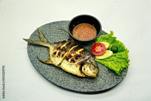 Grilled spadefish (bawal bintang) served with spicy seafood sambal. A savory Indonesian dish rich in flavor, perfect for traditional seafood lovers.