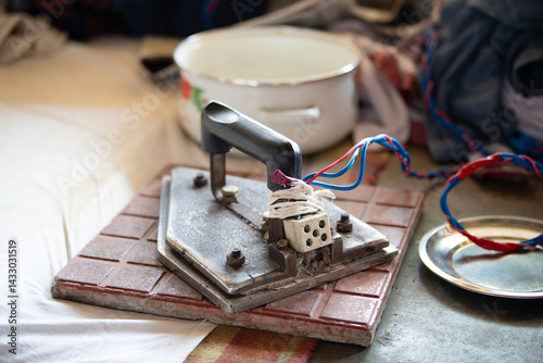 Traditional indian electrical iron, Dhobi Ghat, open air laundry in Kochi, India, old working tool for ironing clothes