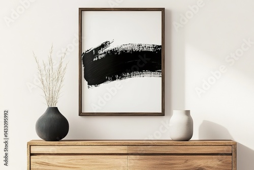modern interior design ,Minimalist, modern black-and-white brush stroke poster, framed and hung above an empty wooden sideboard adorned with vases and decorations.