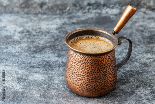 Copper coffee mug with frothy brew photo