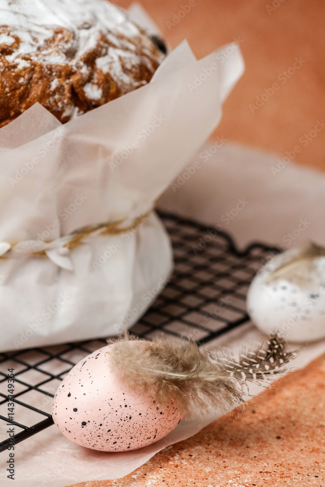 Traditional Easter cake with powdered sugar and speckled eggs on parchment paper. Festive food concept for spring holiday.