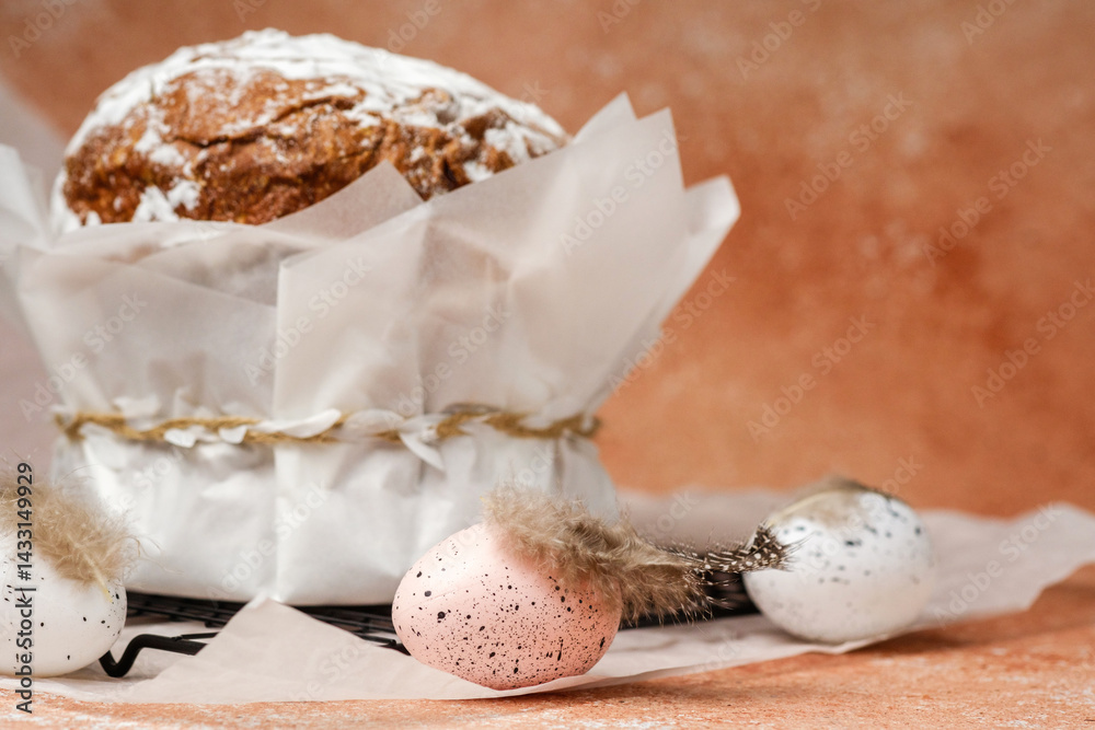 Traditional Easter cake with powdered sugar and speckled eggs on parchment paper. Festive food concept for spring holiday.