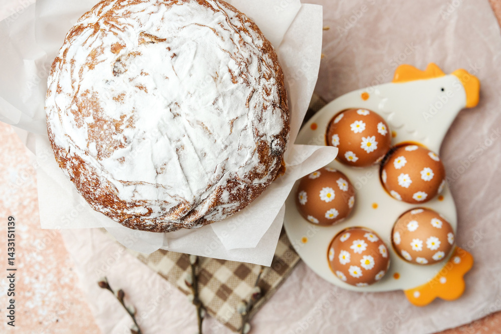 Easter cake and decorated brown eggs with white daisy flowers on ceramic chicken tray. Soft festive still life. Perfect for Easter table concept.
