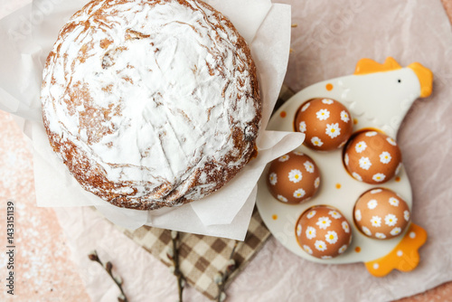 Obraz na płótnie Easter cake and decorated brown eggs with white daisy flowers on ceramic chicken tray. Soft festive still life. Perfect for Easter table concept. w salonie