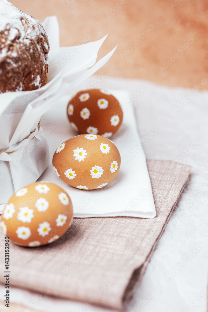 Traditional Easter cake with hand-painted daisy eggs on fabric. Homemade festive baked goods and decor...